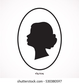 Black silhouette of a woman head in an oval  frame, locket.