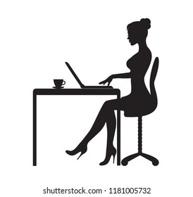 black silhouette of woman sitting at table with laptop. On the table is a mug with tea