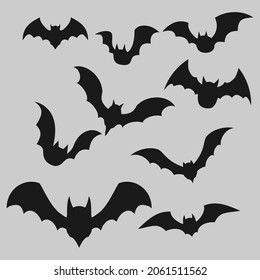 Black silhouettes of bats set on grey background.