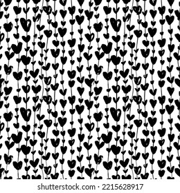 Black silhouettes heart ivy seamless pattern. Brush drawn liana or garland with heart symbols. Thin long vertical branches with leaves ornament. Vector ink illustration for wedding and love holidays. 