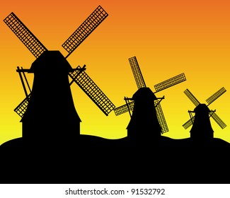 black silhouettes of three wind turbines on an orange background