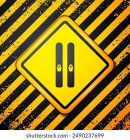 Black Ski and sticks icon isolated on yellow background. Extreme sport. Skiing equipment. Winter sports icon. Warning sign. Vector Illustration