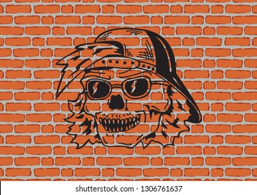 Black skull in a cap painted with paint on a brick wall. Graffiti