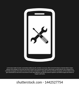 Black Smartphone with screwdriver and wrench icon isolated on black background. Adjusting, service, setting, maintenance, repair, fixing.  Vector Illustration