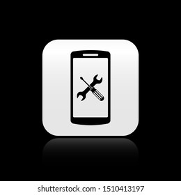 Black Smartphone with screwdriver and wrench icon isolated on black background. Adjusting, service, setting, maintenance, repair, fixing. Silver square button. Vector Illustration