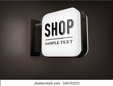 black square signboard with rounded corners, hanging on a wall