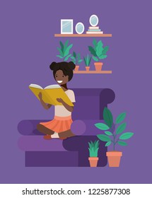 black student girl sitting reading book in livingroom