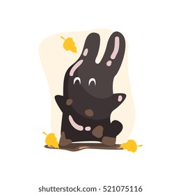 Black Tar Jelly Rabbit Shape Monster Smiling Under Falling Yellow Leaves Outdoors In Autumn Season