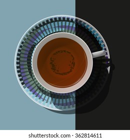 Black tea in a porcelain cup on a saucer with dynamic pattern on the modern background. View from above. 