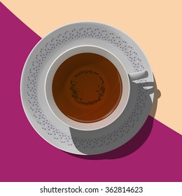 Black tea in a porcelain cup on a white saucer with elegant drawing on the modern background. View from above. 