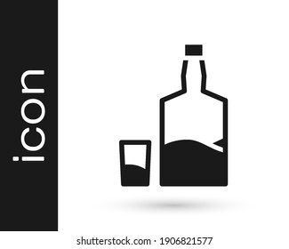 Black Tequila bottle and shot glass icon isolated on white background. Mexican alcohol drink.  Vector