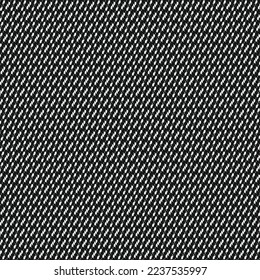 Black textile material, sprinkled with white dots and dashes. Repeated pattern. Textured decorative background.