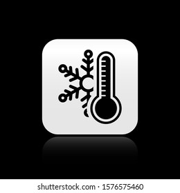 Black Thermometer with snowflake icon isolated on black background. Silver square button. Vector Illustration
