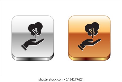 Black Tree in hand of environmental protection icon isolated on white background. Seed and seedling. Planting sapling. Ecology concept. Silver-gold square button. Vector Illustration