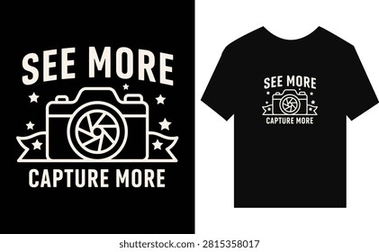 Black tshirt mockup showing graphic design with camera illustration and text reading See More Capture More on a dark background