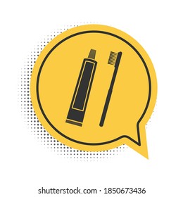Black Tube of toothpaste and toothbrush icon isolated on white background. Yellow speech bubble symbol. Vector.
