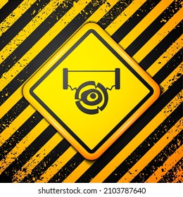 Black Two-handed saw and log icon isolated on yellow background. Warning sign. Vector