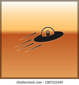 Black UFO flying spaceship and alien icon isolated on gold background. Flying saucer. Alien space ship. Futuristic unknown flying object. Vector Illustration