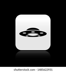 Black UFO flying spaceship icon isolated on black background. Flying saucer. Alien space ship. Futuristic unknown flying object. Silver square button. Vector Illustration