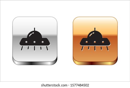 Black UFO flying spaceship icon isolated on white background. Flying saucer. Alien space ship. Futuristic unknown flying object. Silver-gold square button. Vector Illustration