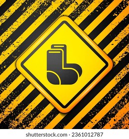 Black Valenki icon isolated on yellow background. National Russian winter footwear. Traditional warm boots in Russia. Warning sign. Vector