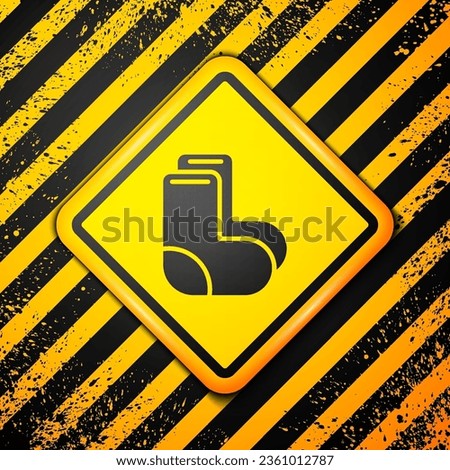 Black Valenki icon isolated on yellow background. National Russian winter footwear. Traditional warm boots in Russia. Warning sign. Vector