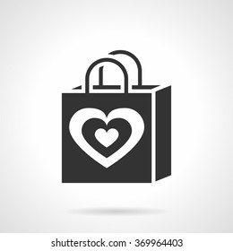 Black Valentines Day shopping bag with heart symbol. Love shopping. Creative holidays gift pack. Vector icon flat silhouette style. Element for web design, business, mobile app.