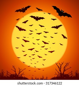 Black vector bats silhouettes on big yellow moon at orange background