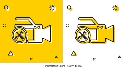 Black Video camera with screwdriver and wrench icon isolated on yellow and white background. Adjusting, service, setting, maintenance, repair, fixing. Random dynamic shapes. Vector Illustration