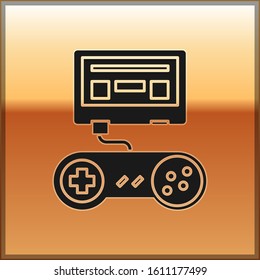 Black Video game console with joystick icon isolated on gold background.  Vector Illustration