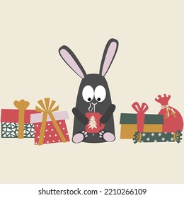 A black water rabbit with gift boxes drinks a hot drink from a mug. Vector illustration of the symbol of 2023. Chinese calendar