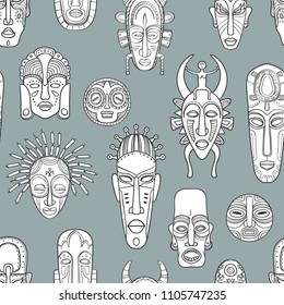 Black and white abstract african mask on a gray background. Vector seamless pattern