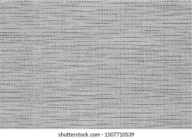 Black and white background of a knitted textile material with pattern lines, shapes, dots, circles. Fabric with a striped texture closeup