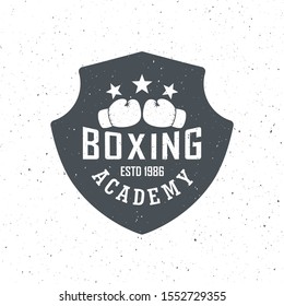 Black and white boxing academy logo illustration with grunge texture. Shield, boxing gloves, stars with text on a white background with texture