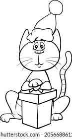 Black and white cartoon illustration of cat animal character with gift on Christmas time coloring book page