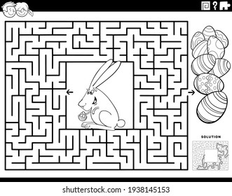 Black and white cartoon illustration of educational maze puzzle game for children with Easter bunny and colored eggs coloring book page