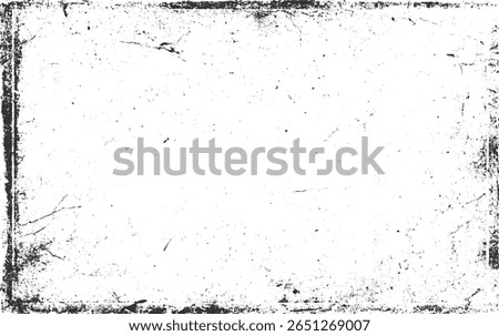 A black and white distressed grunge texture with scattered speckles and cracked edges.