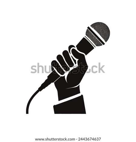 a black and white image of a hand holding a microphone press freedom concept
