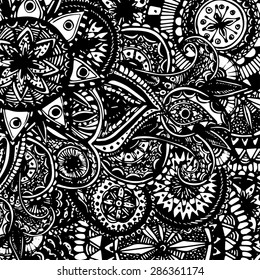 Black and white ornate hand drawn doodles with paisleys and floral elements. Coloring page for adults. Vector graphic background.