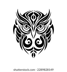 ﻿Tattoo of a black and white owl sporting Polynesian designs.