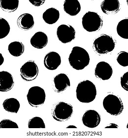 Black and white pattern with bold circles. Seamless ornament with grunge brush circles. Polka dot motif wallpaper. Abstract pattern of bold black shabby dots or spots on white. Hand drawn stains