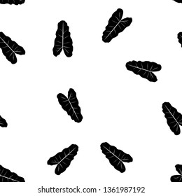 Black and white pattern of tropical leaves. Seamless background with palm leaves.