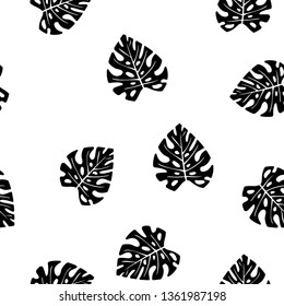 Black and white pattern of tropical leaves. Seamless background with palm leaves.