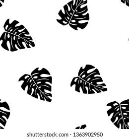 Black and white pattern of tropical leaves. Seamless background with palm leaves.