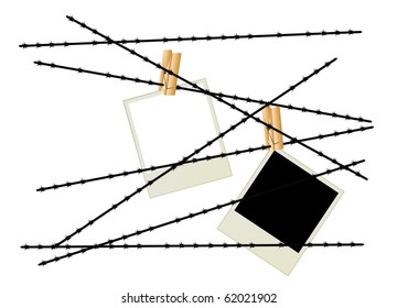 Black and white photos by means of clothespins hang on a barbed wire