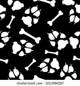 Black and white seamless background with dog or cat paw print and bone. Animal seamless vector pattern of paw footprint and bone. Endless texture for fabric or interior print, web backdrop, design.
