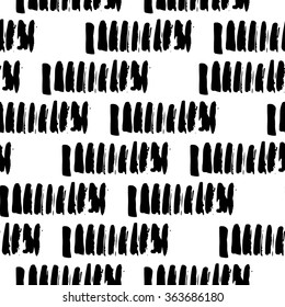 Black and white seamless pattern with calligraphic brush stroke elements. Monochrome tribe aztec style. Good for wallpaper, greeting card, fabric texture, surface design, web page design.