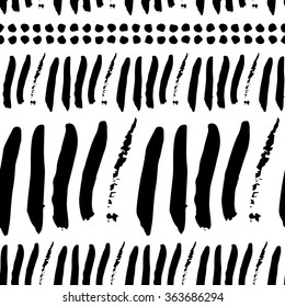 Black and white seamless pattern with calligraphic brush stroke elements. Monochrome tribe aztec style. Good for wallpaper, greeting card, fabric texture, surface design, web page design.