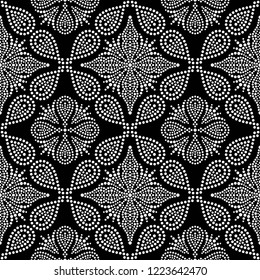 Black and white seamless pattern of dotted flowers, snowflakes, stars in trellis. Mosaic floral print of white dots. Geometric lattice print of beads. Vector Illustration.