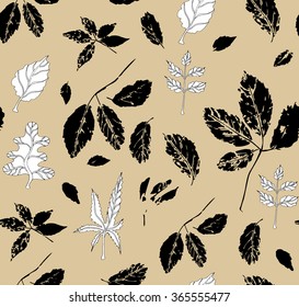 Black and white seamless pattern with leaves of wild grape, ash tree, oak and seeds of maple, against golden background; both drawings and stylized as stamp or imprint; rustic or boho style